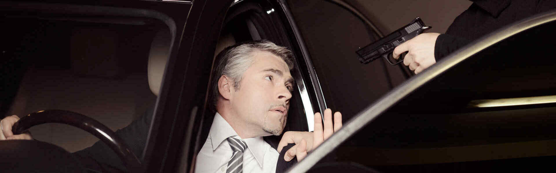 Attacking a businessman. Men in black balaclava holding gun and