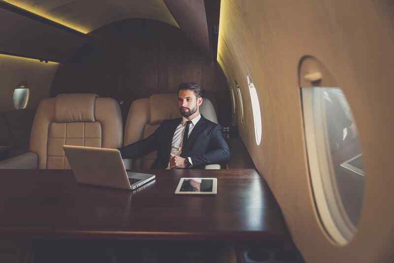 stock-photo-business-man-flying-on-a-private-jet-working-onboard-of-the-airplane-successfull-businessmen-1486503125